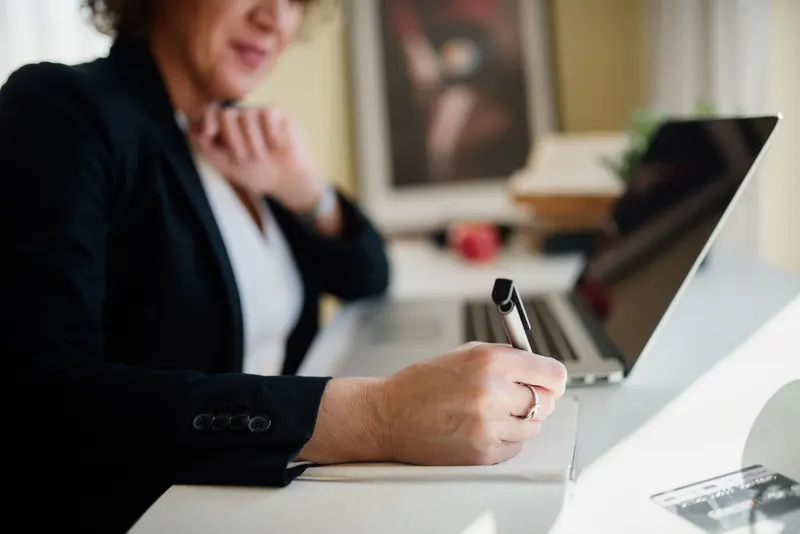 Business owner reviewing a printed service agreement at an office desk