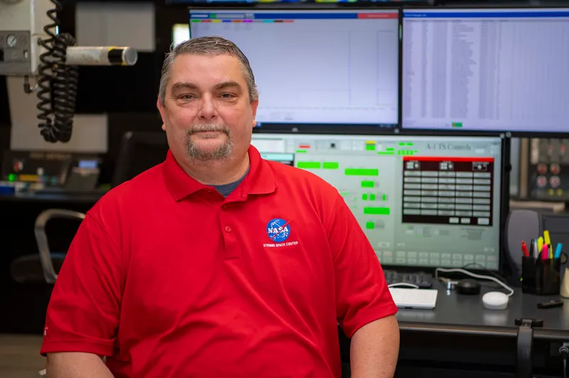 Sales manager reviewing a customer pipeline board on a desktop monitor