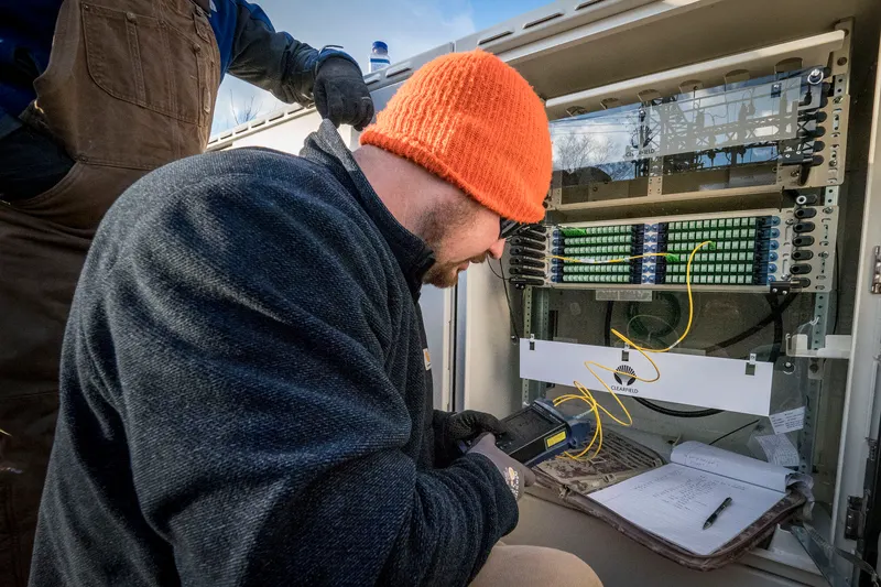 Network engineer inspecting a dedicated fiber circuit in a server room