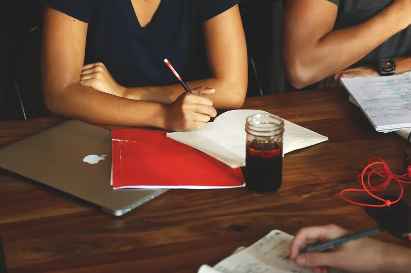 Manager talking with a customer across a desk in a small business office