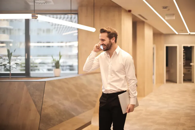 Office worker wearing a headset beside a desk phone
