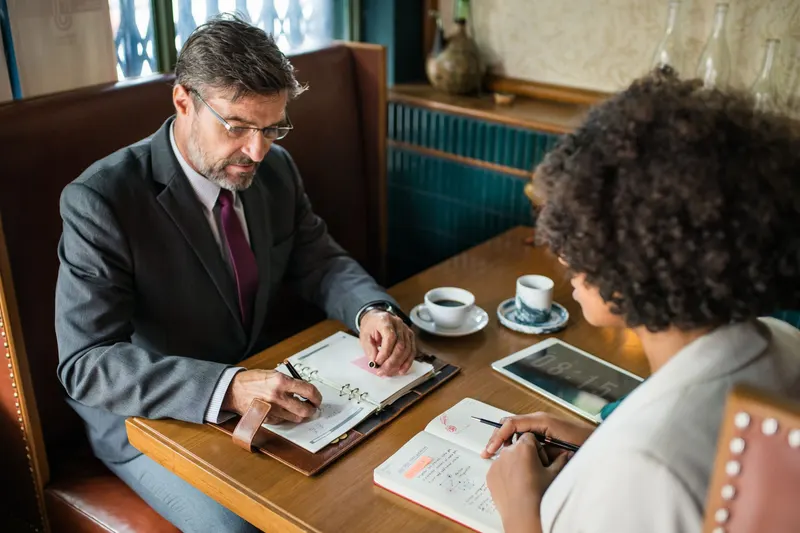 Colleagues reviewing a plan together at a meeting table